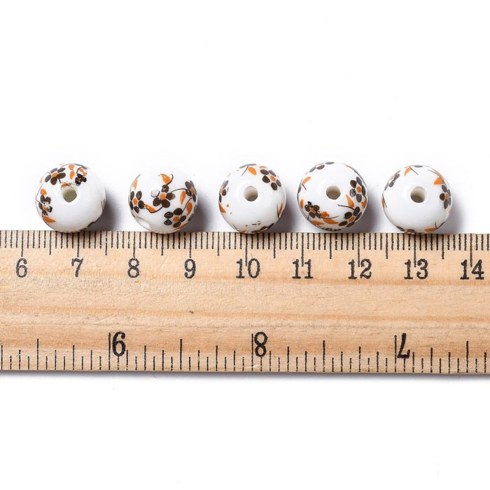 Porcelain bead, white with brown-yellow flowers, round, 12 mm, 4 pieces