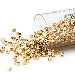 Delica, size #11, 24K gold inlaid hexagonal glass bead, opaque, 1.1x1.7mm, 3,5 grams.