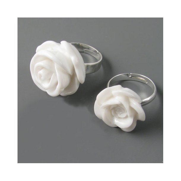 Finger rings with white resin flowers.