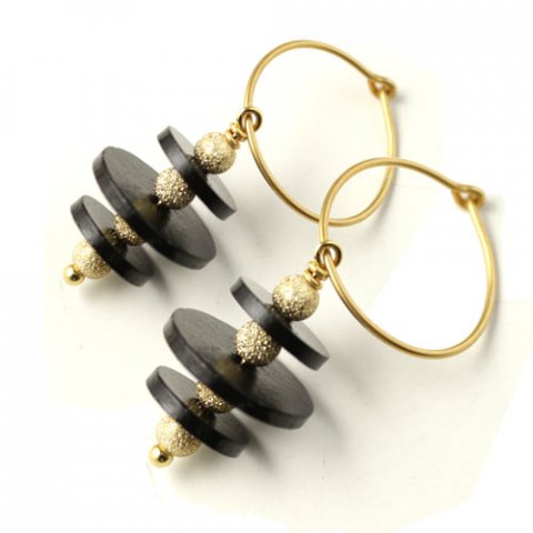 Earrings with black ceramic coins and gilded stardust beads.