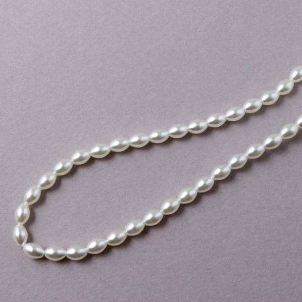 Glass beads, whole strand, rice-shaped, coated, white mother of pearl, 6x4 mm, approx. 100 pcs