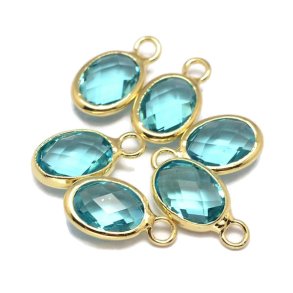 Glass charm, gold plated, oval, light sky blue, 12x7mm, 1pc