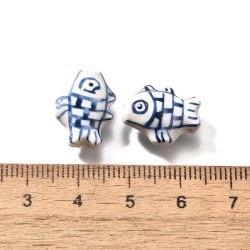 Porcelain beads, hand-painted blue striped fish, approx. 15.5x12x8 mm, 2 pcs
