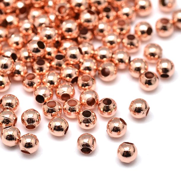 Bead, rose gold plated brass, shiny round, diameter 2 mm. 100 pcs.