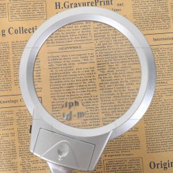 Magnifying glass with a flexible arm, table clamp and LED light.